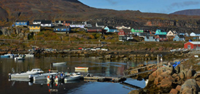 Photo of a Greenlandic village and its harbor.